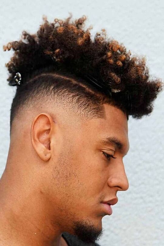 curly mohawk with a shaved part